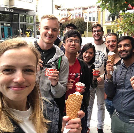 Curated employees with icecream taking a photo.